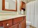 Bathroom featuring tiled floors, vanity with marble countertop, and framed mirror at 1801 Ridgefield Dr, Peachtree City, GA 30269