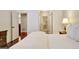 Bright bedroom showing hardwood floors and view into Primary bath and closet at 1801 Ridgefield Dr, Peachtree City, GA 30269