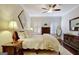 Bright bedroom featuring wood floors, neutral walls, ceiling fan, and matching furniture at 1801 Ridgefield Dr, Peachtree City, GA 30269