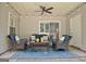Relaxing covered patio featuring comfortable wicker furniture, ceiling fan and decorative string lights at 1801 Ridgefield Dr, Peachtree City, GA 30269