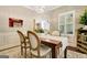 Bright dining area features wood table, white chairs, and seamless flow to other living spaces at 1801 Ridgefield Dr, Peachtree City, GA 30269