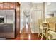 Hallway showcases gleaming hardwood floors and leads to various rooms in the home at 1801 Ridgefield Dr, Peachtree City, GA 30269