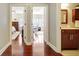 Hallway view highlighting hardwood floors, leading to a bedroom, an office, and a bathroom at 1801 Ridgefield Dr, Peachtree City, GA 30269