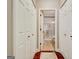 Hallway leading to bathroom with white trim and wood floors at 1801 Ridgefield Dr, Peachtree City, GA 30269