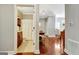 Hallway view into bathroom with wood floors and dark wood vanity cabinet at 1801 Ridgefield Dr, Peachtree City, GA 30269
