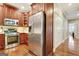 Kitchen features stainless steel appliances, warm wood cabinetry and floors, and ample counter space at 1801 Ridgefield Dr, Peachtree City, GA 30269