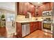 Modern kitchen featuring stainless steel appliances, tile backsplash, and hardwood flooring at 1801 Ridgefield Dr, Peachtree City, GA 30269
