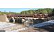 Lake Peachtree dam with waterfall feature and pedestrian bridge at 1801 Ridgefield Dr, Peachtree City, GA 30269