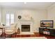 Cozy living room featuring a fireplace, plush seating, and a relaxing atmosphere at 1801 Ridgefield Dr, Peachtree City, GA 30269