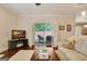 Cozy living room with a comfortable sofa, dark wood floors, and sliding glass doors to the outdoors at 1801 Ridgefield Dr, Peachtree City, GA 30269