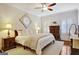 Bedroom suite features neutral tones, tray ceiling, hardwood floors, ceiling fan, and plantation shutters at 1801 Ridgefield Dr, Peachtree City, GA 30269