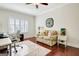 Office area boasts a ceiling fan, wood floors, a desk and a comfortable sofa at 1801 Ridgefield Dr, Peachtree City, GA 30269