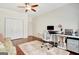 Office space with wood floors, ceiling fan, lots of light, and a white desk at 1801 Ridgefield Dr, Peachtree City, GA 30269