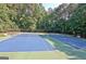 Overview of community tennis courts surrounded by lush trees, offering ample space for recreational play at 1801 Ridgefield Dr, Peachtree City, GA 30269
