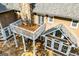 A backyard boasts a wood balcony that sits atop a stone patio and nearby in-ground pool at 115 Champion Dr, Carrollton, GA 30116