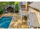 Aerial view showcases a backyard with a pool and a stone patio, perfect for outdoor living at 115 Champion Dr, Carrollton, GA 30116