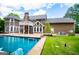 Backyard with a pool, patio and lush green lawn at 115 Champion Dr, Carrollton, GA 30116