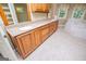 Bright bathroom featuring a large wooden vanity, windows, and tile floor, creating a serene and functional space at 115 Champion Dr, Carrollton, GA 30116