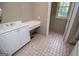 Bathroom featuring a sink, built-in desk area, and tile flooring at 115 Champion Dr, Carrollton, GA 30116