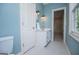 Bathroom featuring light blue walls and white vanity with tile floor at 115 Champion Dr, Carrollton, GA 30116