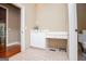 Neutral-toned bathroom with a built-in desk area and tile flooring at 115 Champion Dr, Carrollton, GA 30116