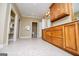 Bathroom boasting a long wood vanity, tile floors, a makeup area, and a walk-in closet, offering ample storage at 115 Champion Dr, Carrollton, GA 30116