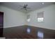 Bedroom featuring hardwood floors, two windows, and neutral colored walls at 115 Champion Dr, Carrollton, GA 30116