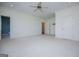 Bright bedroom with neutral walls, white trim, ceiling fan, and plush carpet at 115 Champion Dr, Carrollton, GA 30116