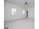 Empty bedroom with neutral carpet, two windows, ceiling fan, and recessed lights at 115 Champion Dr, Carrollton, GA 30116