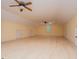 Spacious bonus room featuring hardwood floors, doors, and yellow walls at 115 Champion Dr, Carrollton, GA 30116