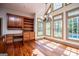 Bright breakfast nook with custom cabinets, built-in desk, and lots of windows with outdoor views at 115 Champion Dr, Carrollton, GA 30116