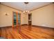 Dining room with hardwood floors, chandelier, and double doors at 115 Champion Dr, Carrollton, GA 30116