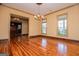 Formal dining room with hardwood floors, chandelier, and three windows at 115 Champion Dr, Carrollton, GA 30116