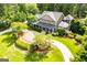Expansive home featuring a front porch, beautiful landscaping and a circular driveway at 115 Champion Dr, Carrollton, GA 30116