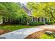 Home featuring a large covered front porch and mature landscaping at 115 Champion Dr, Carrollton, GA 30116
