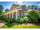 Two-story home with a large front porch and mature landscaping at 115 Champion Dr, Carrollton, GA 30116
