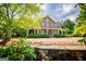 Two-story home featuring a wraparound porch and landscaped front yard at 115 Champion Dr, Carrollton, GA 30116