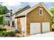 Spacious two-car garage with cedar shingle siding and white doors at 115 Champion Dr, Carrollton, GA 30116