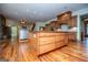 Spacious kitchen with custom wood cabinets, oversized island, and stone accent wall, creating a warm and inviting space at 115 Champion Dr, Carrollton, GA 30116