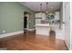 Kitchen space offering an island, white cabinets, stainless steel appliances, and hardwood floors for a modern feel at 115 Champion Dr, Carrollton, GA 30116