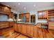 Well-designed kitchen featuring a large island with granite countertops, custom cabinets, and stainless steel appliances at 115 Champion Dr, Carrollton, GA 30116