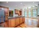 Bright kitchen with large island, stainless steel appliances, custom cabinets, and adjacent breakfast nook with large windows at 115 Champion Dr, Carrollton, GA 30116