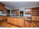 Well-designed kitchen featuring a large island with granite countertops, custom cabinets, and stainless steel appliances at 115 Champion Dr, Carrollton, GA 30116