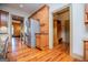Well-equipped kitchen with stainless steel appliances and custom cabinets leading to a mudroom area at 115 Champion Dr, Carrollton, GA 30116