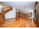 View of the hardwood floors, stone fireplace and staircase in the living room at 115 Champion Dr, Carrollton, GA 30116