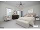 Staged main bedroom boasts a neutral palette, plush bedding, and bright natural light at 115 Champion Dr, Carrollton, GA 30116