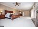 Expansive primary bedroom with fireplace, carpet, and traditional furniture at 115 Champion Dr, Carrollton, GA 30116