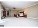 Expansive primary bedroom with fireplace, carpet, and neutral paint at 115 Champion Dr, Carrollton, GA 30116