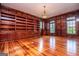 Office with custom built-in shelving, wood paneling and hardwood floors at 115 Champion Dr, Carrollton, GA 30116