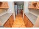 Spacious pantry with wood floors and cabinets with granite countertops perfect for kitchen storage and organization at 115 Champion Dr, Carrollton, GA 30116
